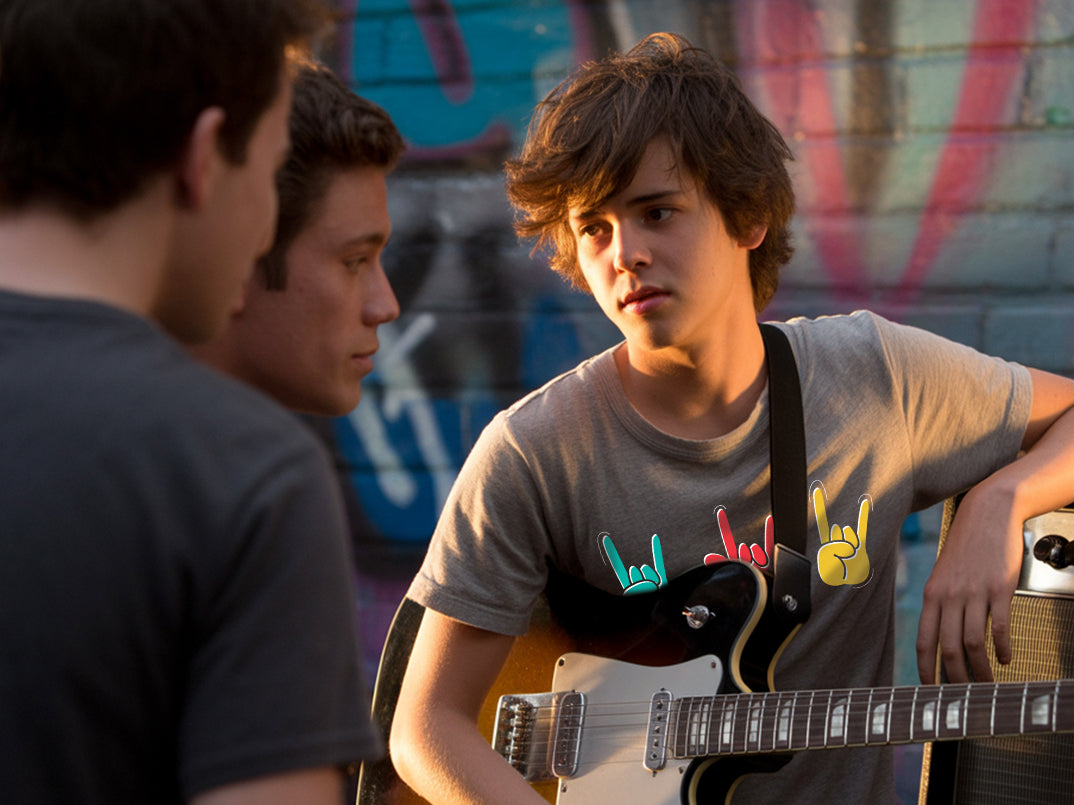Boy showing others playing the guitar